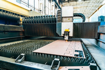 Process of cutting metal. CNC Laser plasma cutter machine in industrial metalwork factory.