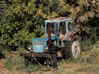 Old rusty blue tractor on the farm.