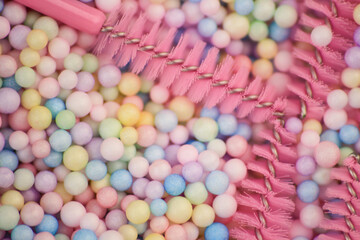 Materials for eyelash extension. Brushes, accessories for eyelash extensions. Colorful balls background