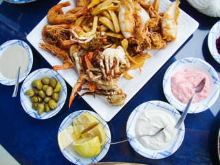 mediterranean cuisine. seafood. table setting. authentic greek meze style dishes on the table
