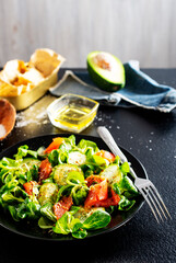 Fresh salad with avocado, cucumber, salmon. Dressing with honey, dijon mustard, olive oil and lemon juice
