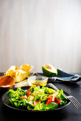 Fresh salad with avocado, cucumber, salmon. Dressing with honey, dijon mustard, olive oil and lemon juice