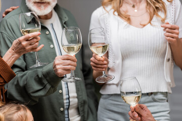 cropped view of family toasting with wine glasses during easter celebration.