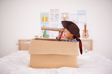 Shiver me timbers. A little pirate spying land from his cardboard box boat.