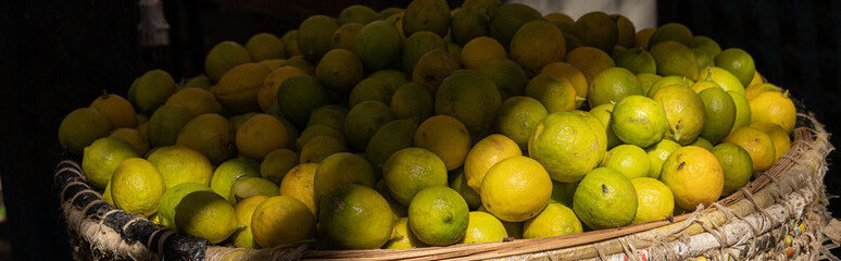 Heap of fresh Limes in local market. Dramatic light