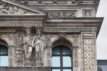 Obraz premium Detail of the exterior architecture of the Louvre in Paris with its sculptures and statues