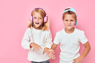a boy in a cap and a girl standing side by side posing fashion lifestyle childhood