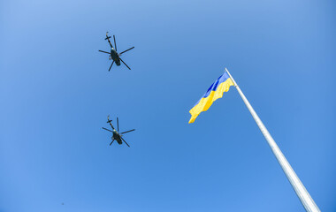 Russian military planes fly next to the flag of Ukraine
