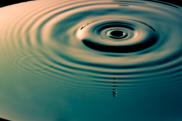  water drop splash forming a wave in the water