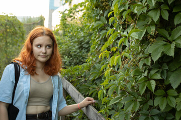 The girl near the thickets. Red-haired woman.