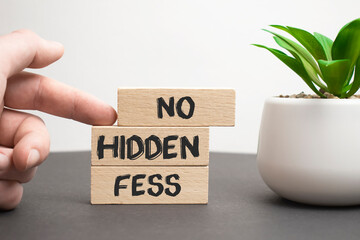 No hidden fees word written on wood block. No hidden fees text on wooden table for your desing, Top view concept.
