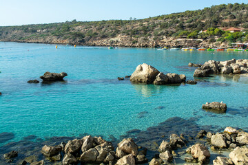 Crystal clear blue water of Mediterranean sea  and yellow rocks in on Konnos beach near Protaras, Cyprus