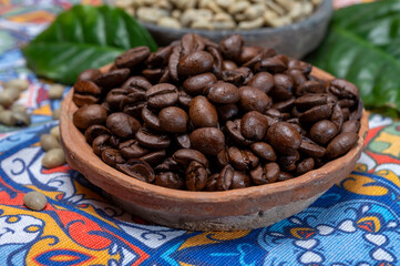 Green and roasted coffee beans from South America coffee producing region, from Colombia and Brazil with  mountain ranges and climate ideal for coffee growing