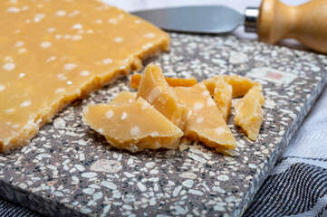 72 months very old Italian parmigiano-reggiano parmesan cheese from Parma has amber color, dry, extremely grainy and crumbly with very intense taste.
