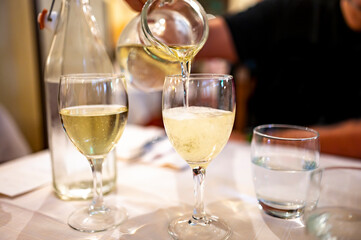 Italian white house wine served in pitcher with two glasses for dinner