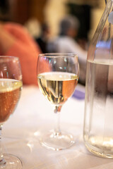 Italian white house wine served in pitcher with two glasses for dinner