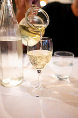 Italian white house wine served in pitcher with two glasses for dinner
