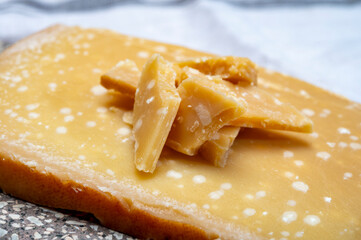 72 months very old Italian parmigiano-reggiano parmesan cheese from Parma has amber color, dry, extremely grainy and crumbly with very intense taste.