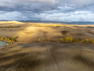 Aerial view on hills of Tuscany, Italy. Tuscan landscape with ploughed fields in autumn.