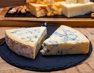 British cheeses collection, blue Stilton, Scottish coloured and English matured cheddar cheeses