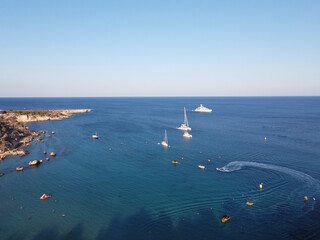 Crystal clear blue water of Mediterranean sea  and yellow rocks in on Konnos beach near Protaras, Cyprus