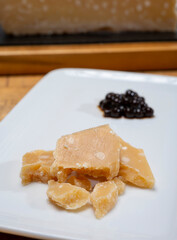 Tasting of 72 months very old Italian parmigiano-reggiano parmesan cheese from Parma  with extremely grainy with black pearls of balsamic vinegar DOP from Modena.