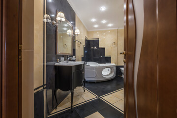 toilet and detail of a corner shower cabin with wall mount shower attachment