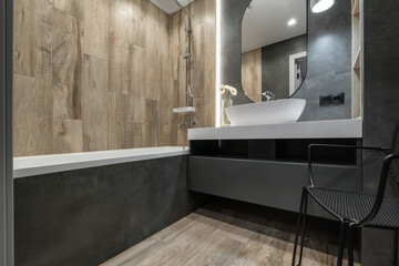 toilet and detail of a corner shower cabin with wall mount shower attachment
