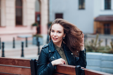 Fototapeta premium Beautiful woman looking back over her shoulder.Woman in city