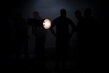 Behind the scenes or making of film video production and movie crew team working in silhouette of...
