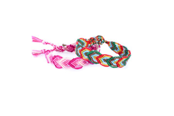 Woven DIY friendship bracelets handmade of embroidery bright thread with knots on white background