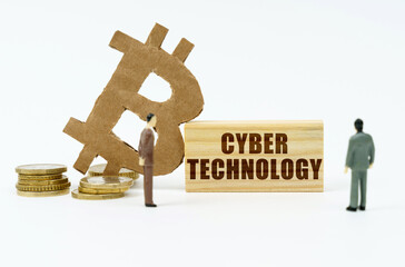 On a white surface, the bitcoin symbol, human figures and a wooden plate with the inscription -