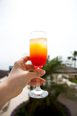 glass with a drink on the background of the hotel