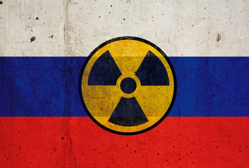 Russian flag on wall and radioactive symbol. Concept of nuclear weapons