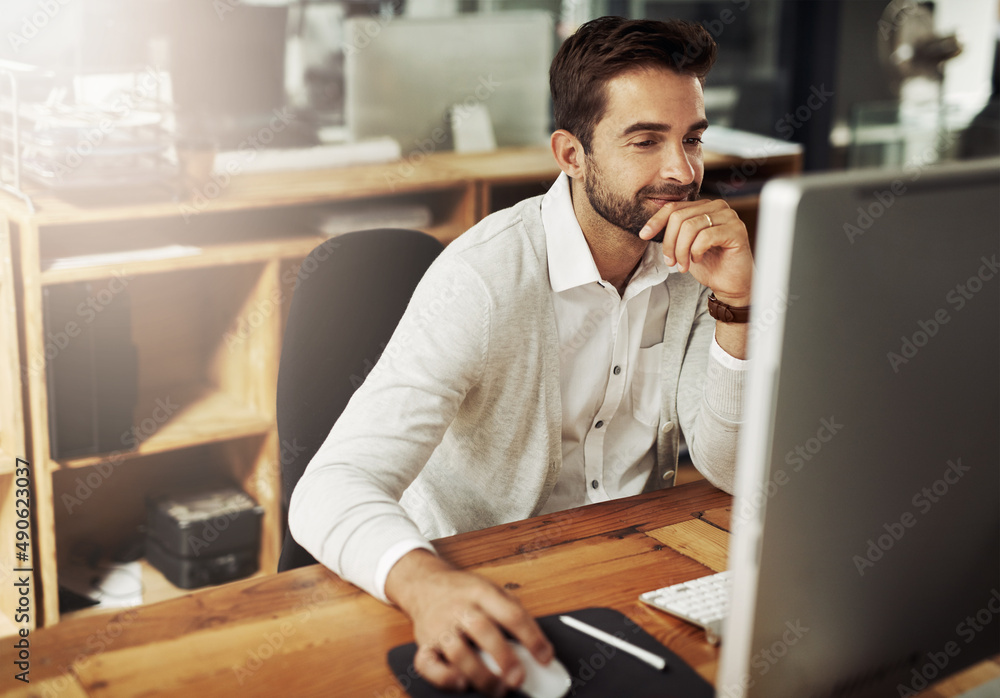 Poster doing whatever it takes to stay on schedule. shot of a handsome young businessman working late on a 