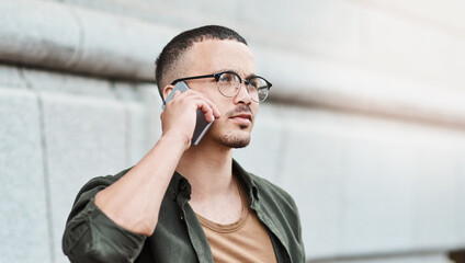 Slay the day your way. Shot of a young businessman using a smartphone against an urban background.