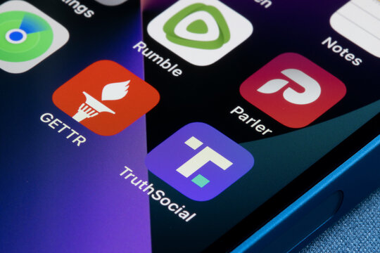 Portland, OR, USA - Mar 3, 2022: Truth Social, Gettr, Rumble and Parler app icons are seen on an iPhone. Donald Trump's new social media venture, Truth Social, launched on Feb 20 in Apple's App Store.