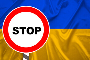national flag of European state of Ukraine on a luxurious texture of satin, red stop sign, silk with waves, folds and highlights, close-up, copy space, travel concept, economy and state policy