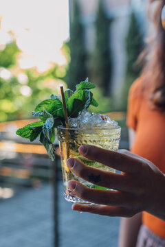 Woman Hand Holding Mint Julep Cocktail Outdoors