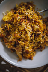 Persian Saffron Barberry Rice with Chicken single serving on white dish (Zereshk Polo ba morgh Irani)