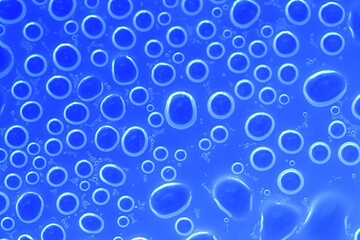 Water bubbles surface.wallpaper phone. background with round drops in blue tones. Water bubbles and drops texture.blue circles pattern