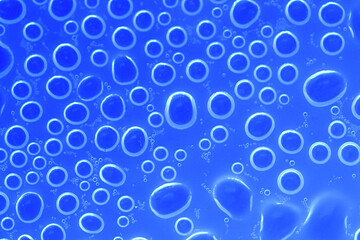 Water bubbles surface.wallpaper phone. background with round drops in blue tones. Water bubbles and drops texture.blue circles pattern