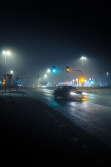 car on city street in dark and foggy night