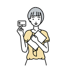 立って書類とカードを手に持つオフィスカジュアルの女性