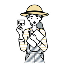 立って書類とカードを手に持つ農家の女性