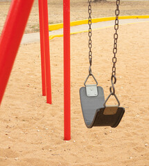 An empty swing in Allcorn Park, a public park in Brownwood Texas.