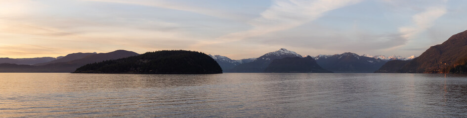 Panoramic View of Canadian Nature Mountain Landscape on the Pacific Ocean West Coast. Colorful Winter Sunset. Taken in Howe Sound near Horseshoe Bay, West Vancouver, BC, Canada. Background Panorama