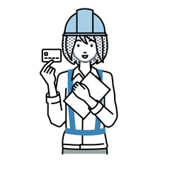 立って書類とカードを手に持つ工事現場の女性