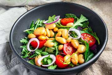 white bean salad , tomato, leaves lettuce mix fresh healthy meal food diet snack on the table copy space food background 