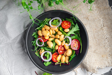 white bean salad , tomato, leaves lettuce mix fresh healthy meal food diet snack on the table copy space food background 